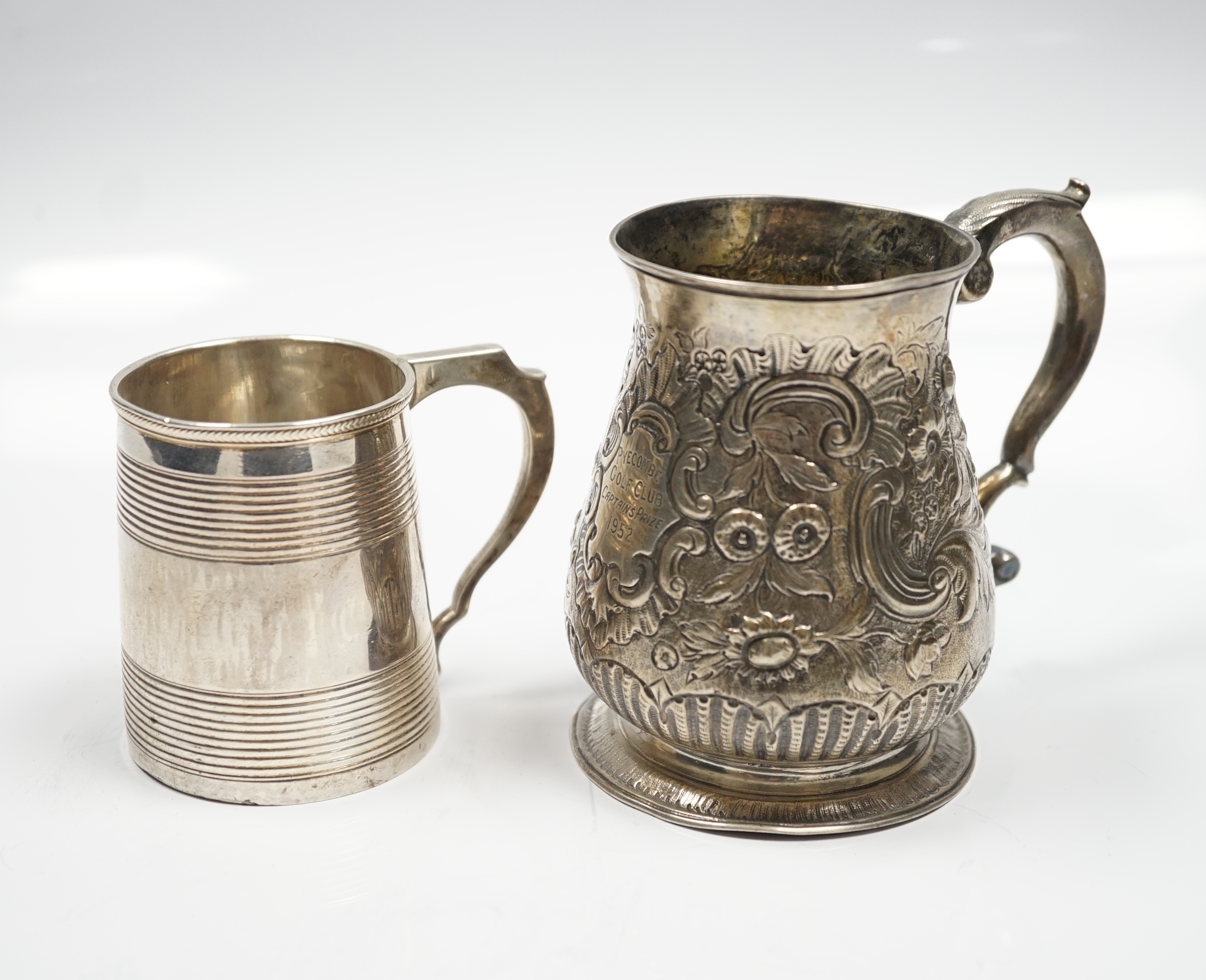 A late George II silver baluster mug, with later embossed decoration, William Shaw II?, London, 1756, 93mm, together with a George III reeded silver small christening mug, London, 1814.